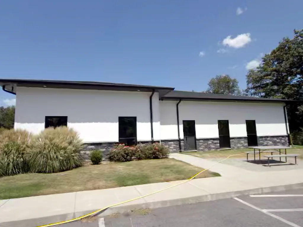 Commercial building landscape side in Heber Springs, Arkansas after soft washing — clean, streak-free exterior