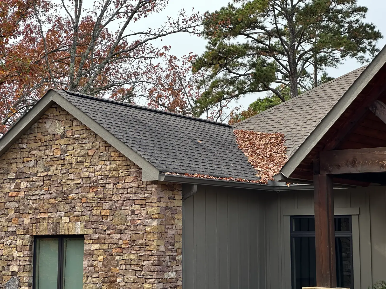 Asphalt shingle roof cleaned of black algae streaks on a stone home in Heber Springs