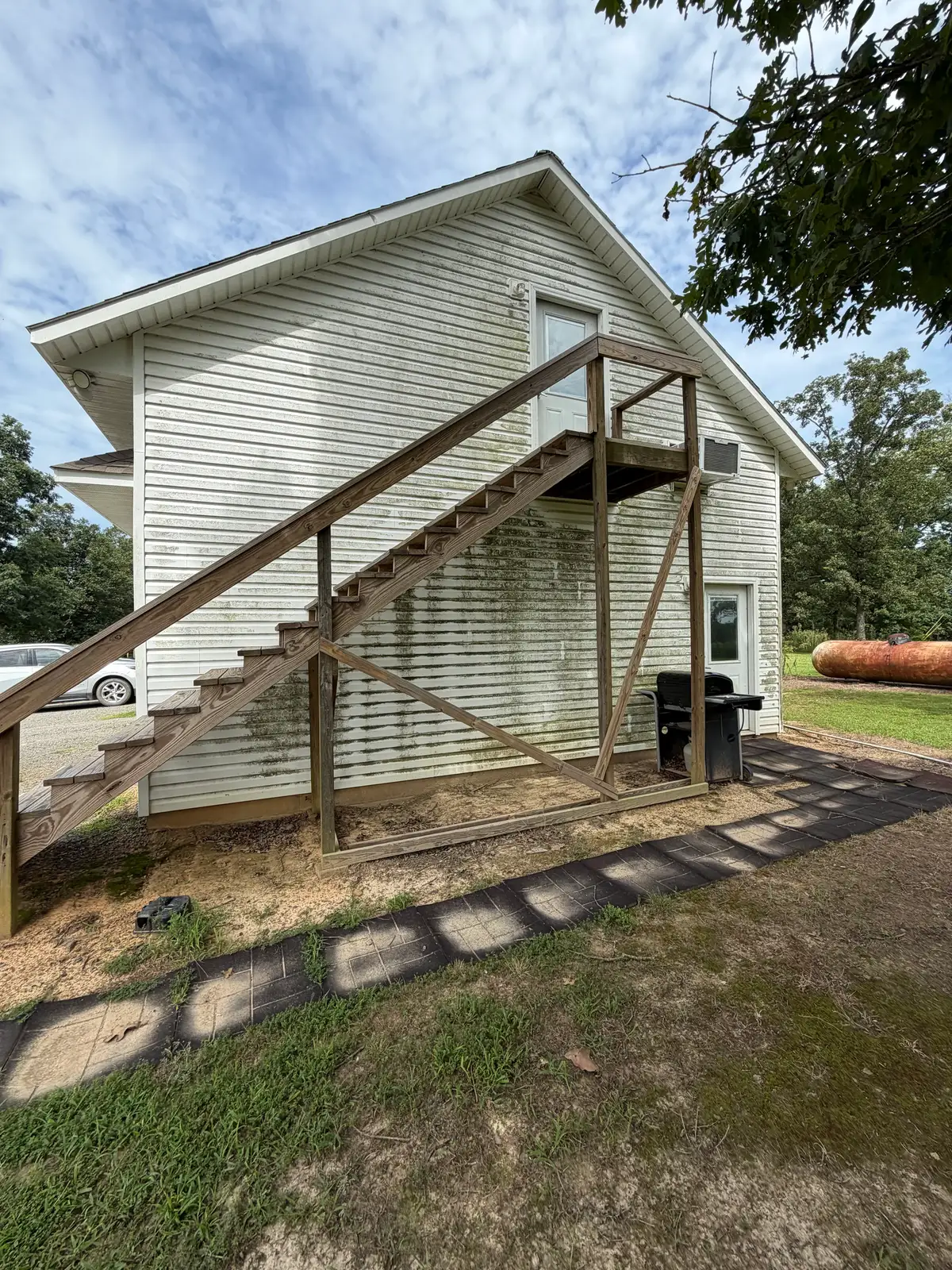 Upper walls and stairway of a commercial property soft washed in Heber Springs