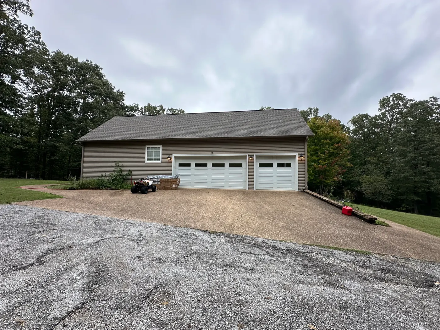 Concrete driveway power washed clean in front of a residential garage in Heber Springs