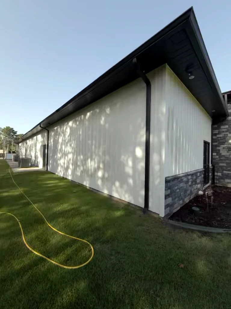 Commercial building gable wall in Heber Springs, Arkansas before soft washing — algae and weather staining on the exterior