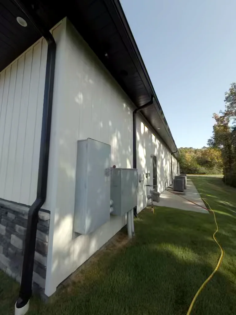 Commercial building utility side in Heber Springs, Arkansas before soft washing — algae and weather staining on the exterior