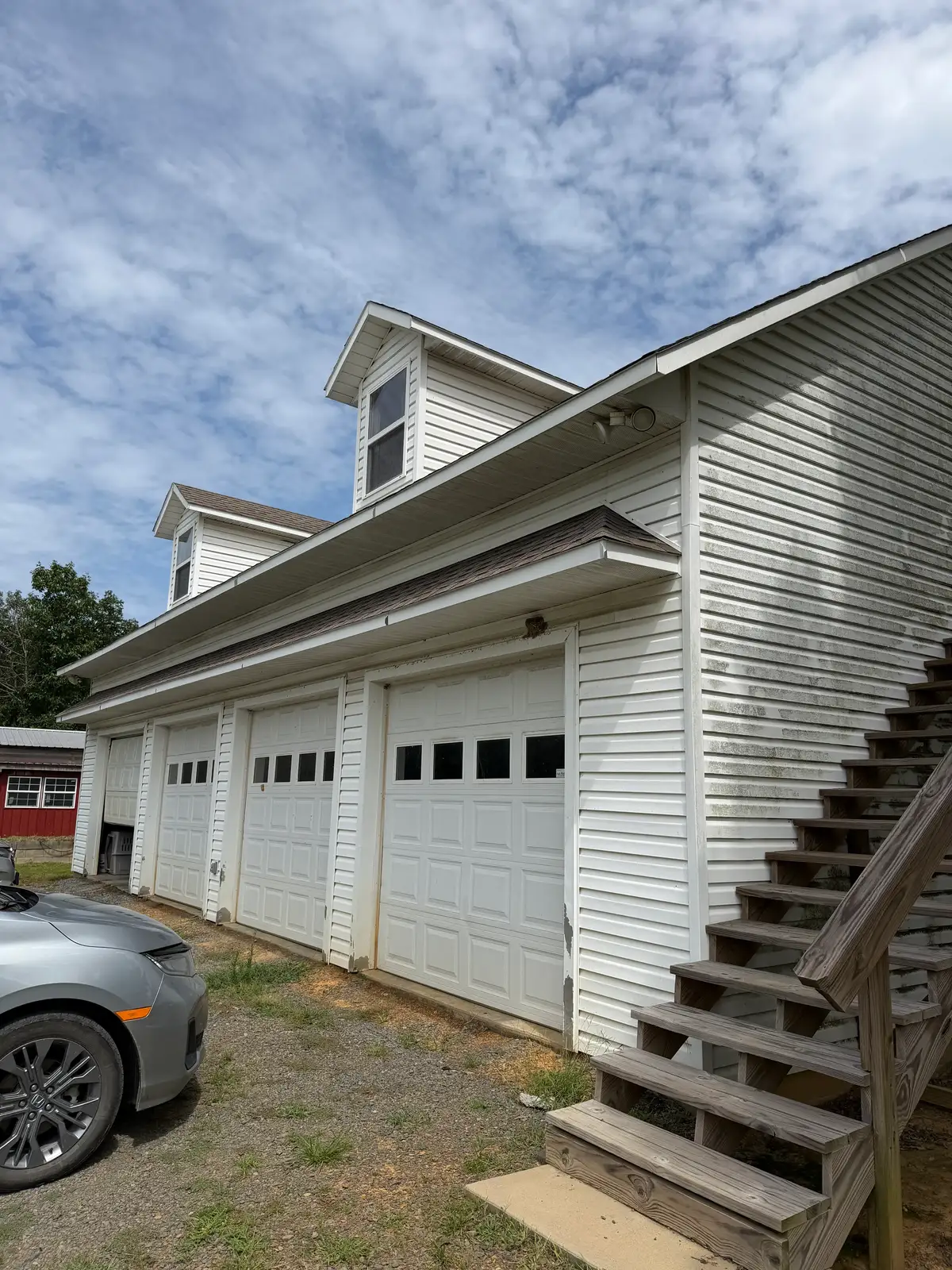 Commercial garage bay exterior soft washed in Central Arkansas