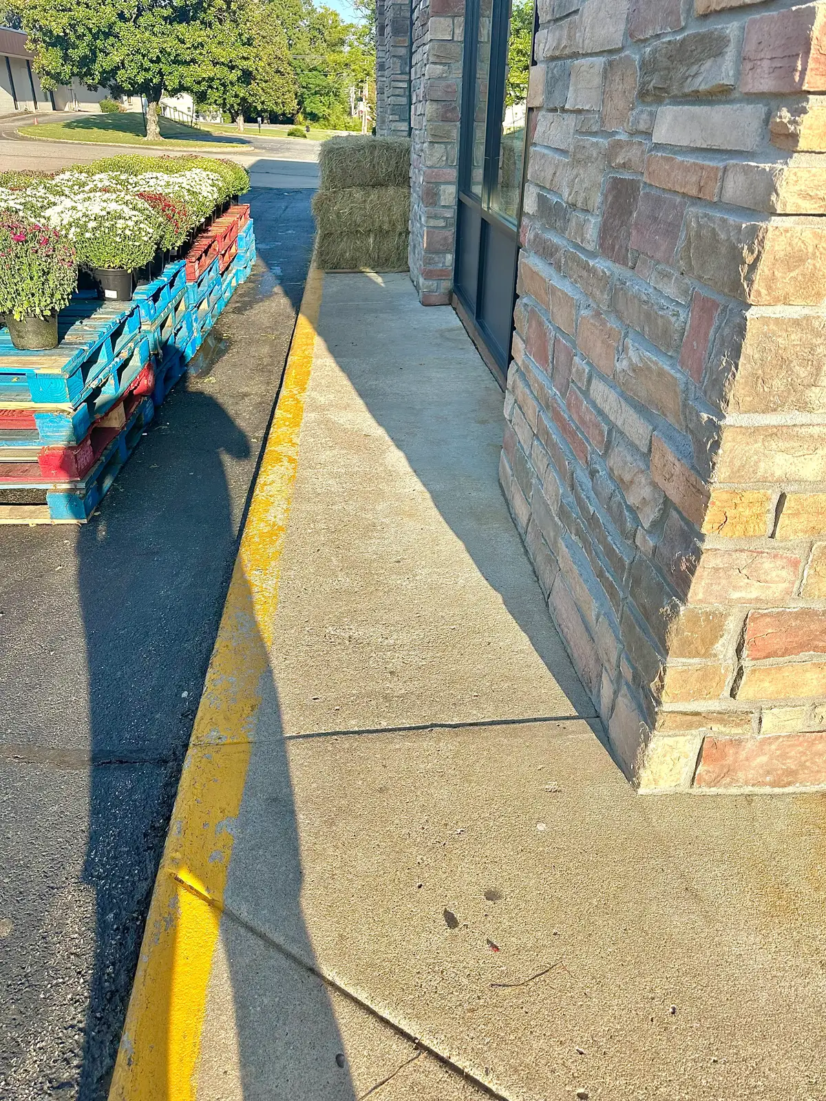 Commercial storefront sidewalk cleaned alongside residential service work in Heber Springs